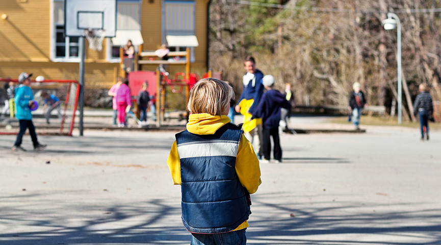 En elev står ensam på en skolgård